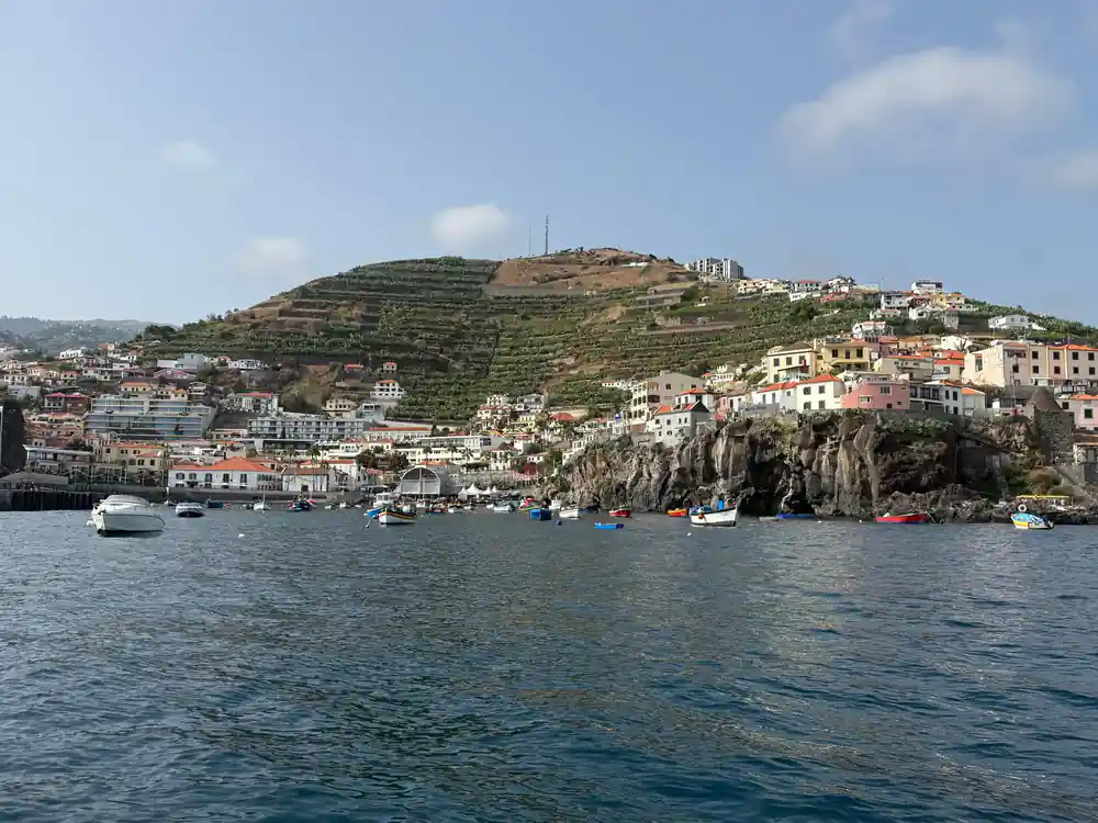 the village of Camara de Lobos on its headland seen from the water